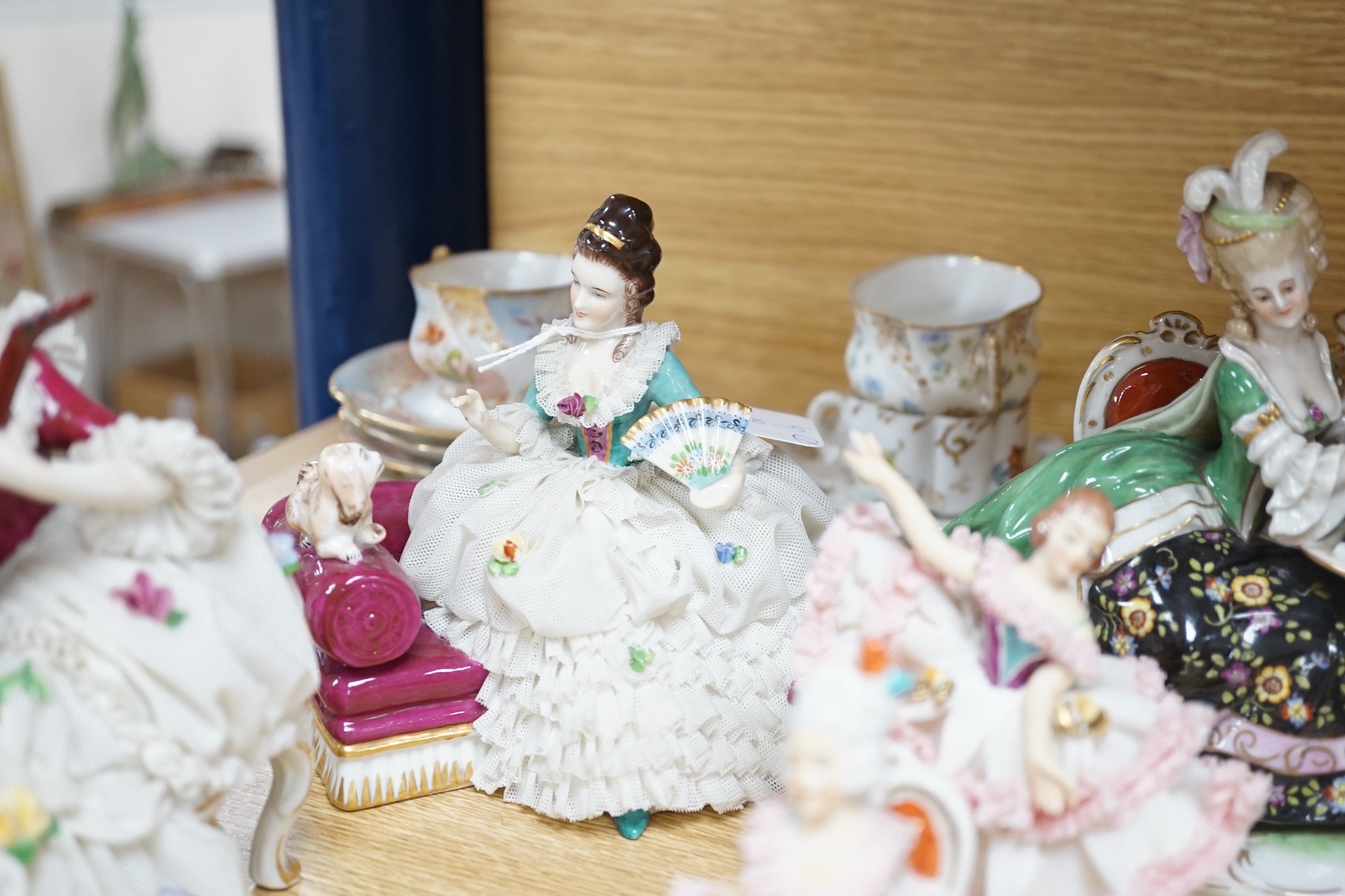 A group of Continental porcelain cabinet cups and saucers, a vase, crinoline figures and a Meissen horse, horse 9 cms high